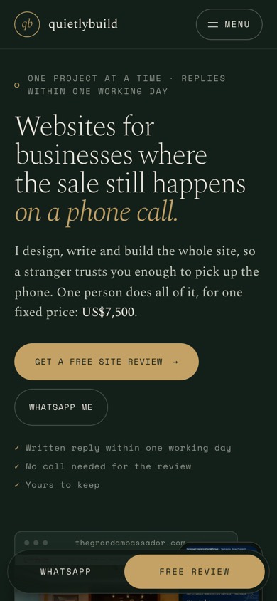 quietlybuild.in’s previous design, the first screen on a phone: a dark green page with gold type, two buttons in small capitals, and the first client’s site just starting under the WhatsApp bar.