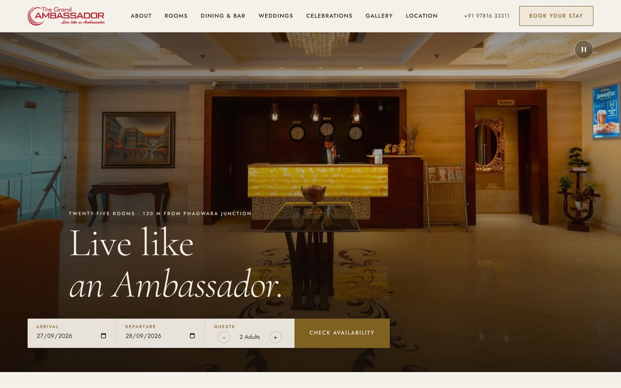 The Grand Ambassador’s home page on a laptop: ‘Live like an Ambassador’, twenty-five rooms 130 metres from Phagwara Junction, with the front desk’s number at the top right and a booking form.